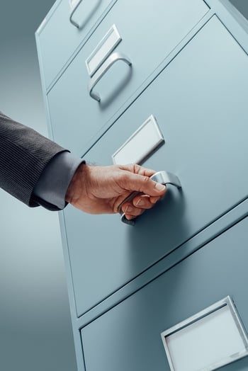 office-clerk-searching-files-in-the-filing-cabinet-2021-08-26-22-39-51-utc
